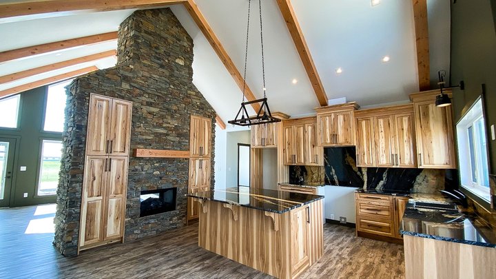 Valemount Kitchen, fireplace and beams nelson homes.jpg